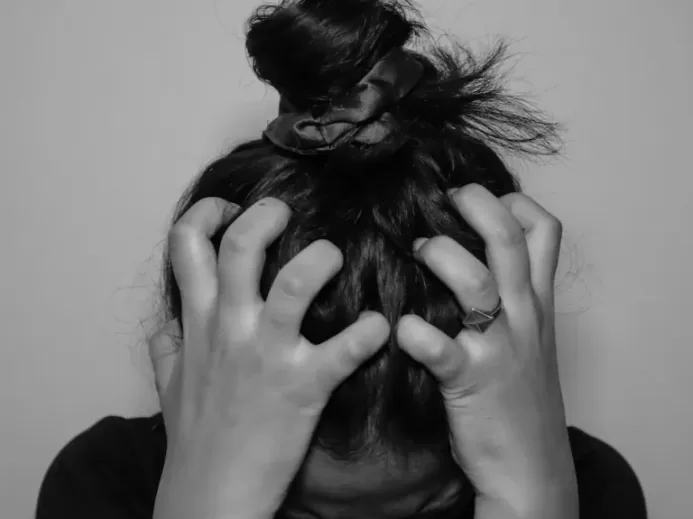 a woman covering her face with her hands