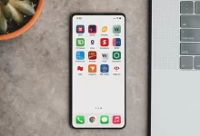 a cell phone sitting next to a laptop computer