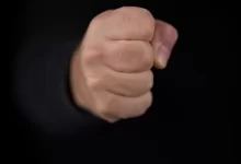 persons fist on black background