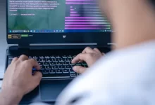 a man sitting in front of a laptop computer