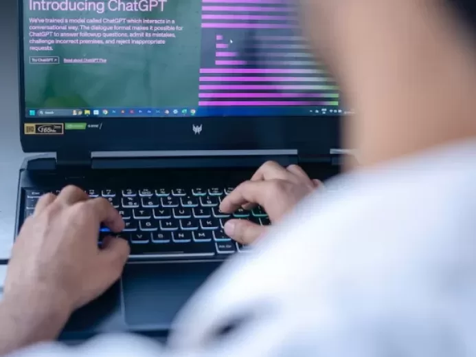 a man sitting in front of a laptop computer