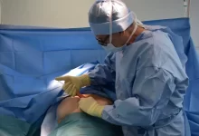 a person in a hospital gown operating a machine