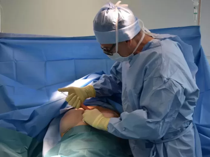 a person in a hospital gown operating a machine