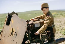 a boy in a military uniform working on a machine