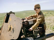a boy in a military uniform working on a machine