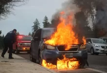 man in black jacket standing near fire