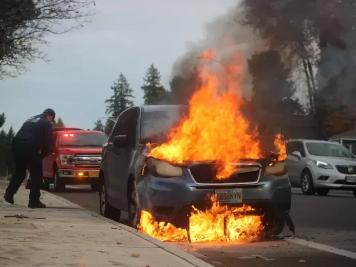 man in black jacket standing near fire