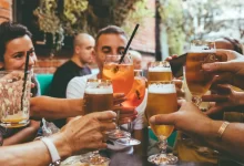 people holding drinks during day