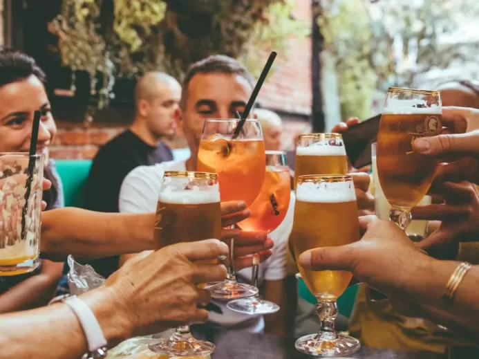 people holding drinks during day