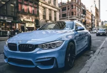 blue BMW coupe parked on the road during daytime
