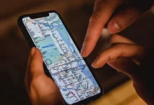 Crop couple with map on smartphone
