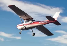 red and white airplane flying in the sky during daytime