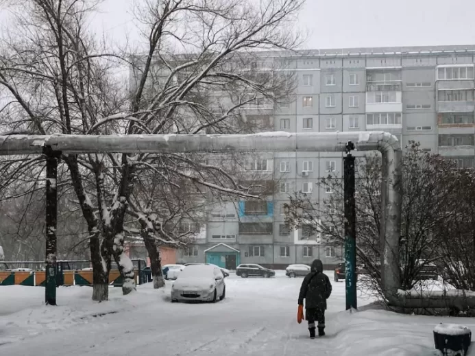 a person walking down a snow covered street