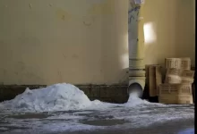 a pile of snow sitting next to a light pole