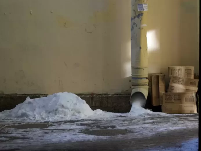 a pile of snow sitting next to a light pole