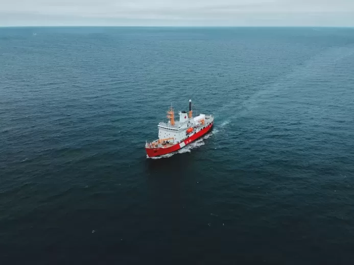 red and white ship on sea during daytime