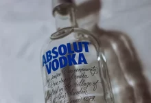 clear glass bottle on white textile