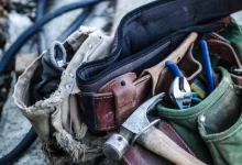 brown handled hammer and with tool belt