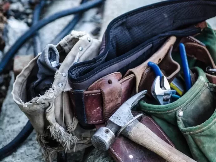 brown handled hammer and with tool belt