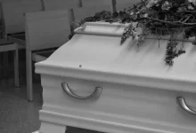 White Coffin with Flowers in Grayscale Photography