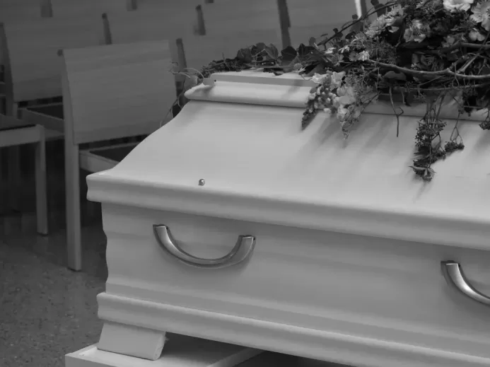 White Coffin with Flowers in Grayscale Photography