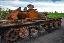 a rusted out tank on a road
