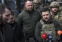 Zelensky, with his chief of staff Andriy Yermak, center, speaks to journalists in Bucha on April 4