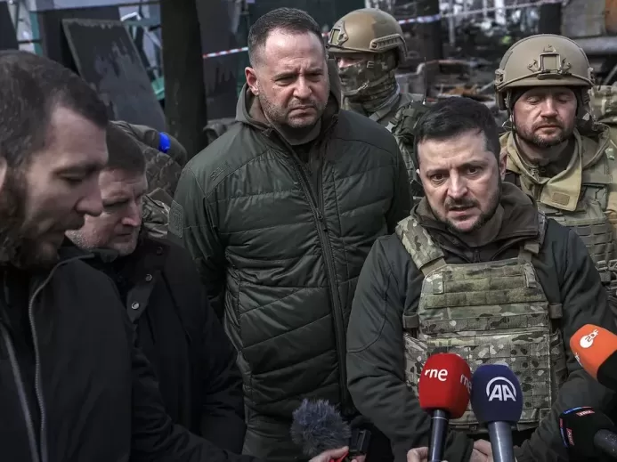Zelensky, with his chief of staff Andriy Yermak, center, speaks to journalists in Bucha on April 4