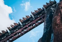 a roller coaster with many cars on top of it