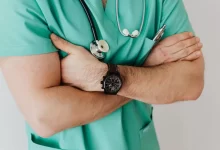 Unrecognizable crop man in wristwatch with stethoscope