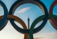 the olympic rings in front of the eiffel tower