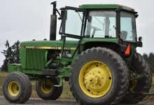 green tractor on brown soil