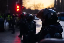 people in black jacket and helmet on street during daytime