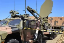 a military vehicle with a satellite dish on top of it