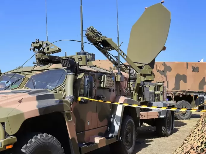 a military vehicle with a satellite dish on top of it