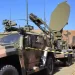 a military vehicle with a satellite dish on top of it