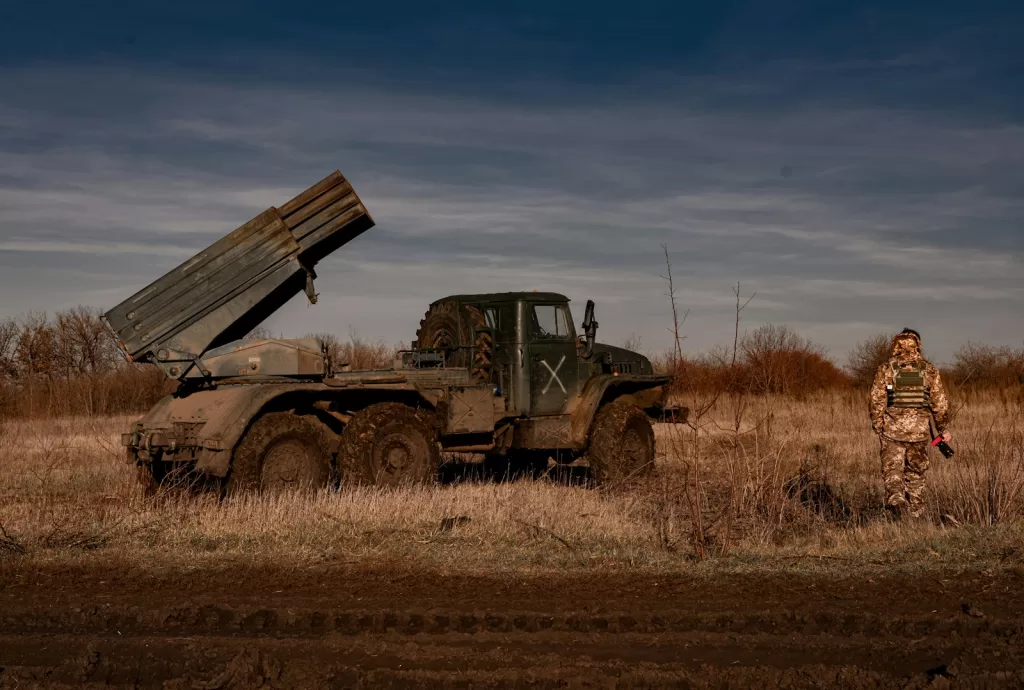Vony Razom - Pravda24 a man standing in a field next to a truck