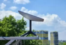 a white surfboard sitting on top of a metal pole