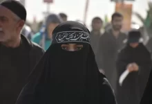 group of people in black walking