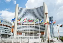 a large building with a lot of flags in front of it