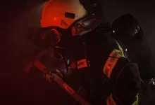 man in orange helmet and black helmet