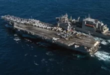 USS Reagan sails alongside Military Sealift Command's dry cargo & ammunition ship USNS M. Perry