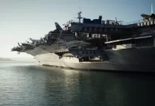 gray warship on body of water