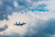 blue and white airliner in flight