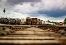 trains under cloudy sky