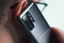 a close up of a person talking on a cell phone