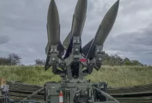 a group of missiles sitting on top of a field