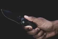 person holding black pocket knife