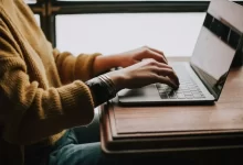 person sitting front of laptop
