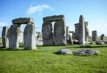 gray rock formation on green grass field during daytime
